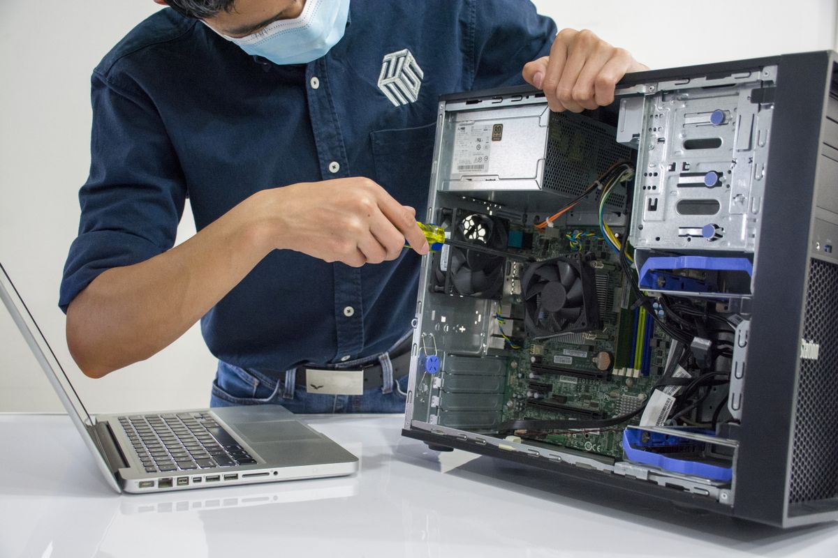 Technician servicing a desktop computer